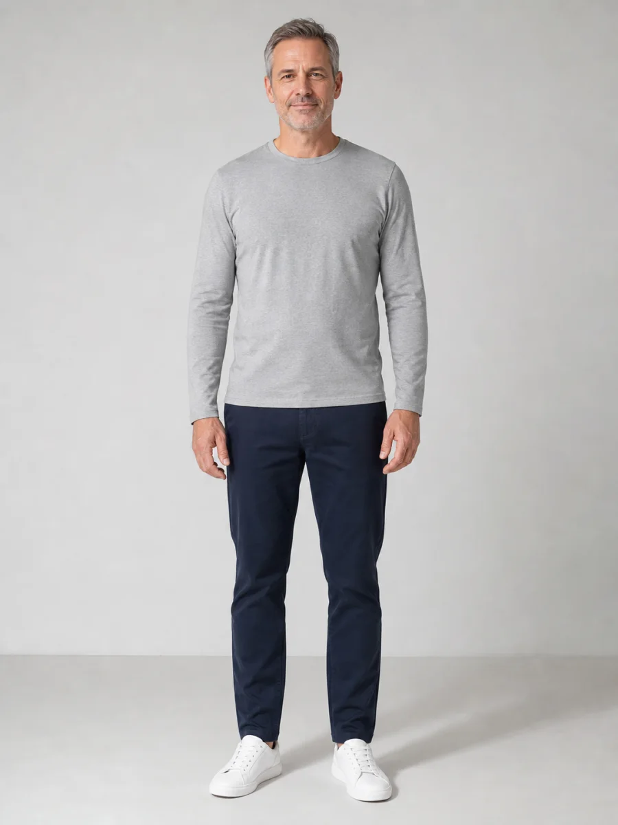 Man in a gray shirt and navy chinos before a seasonal outfit change